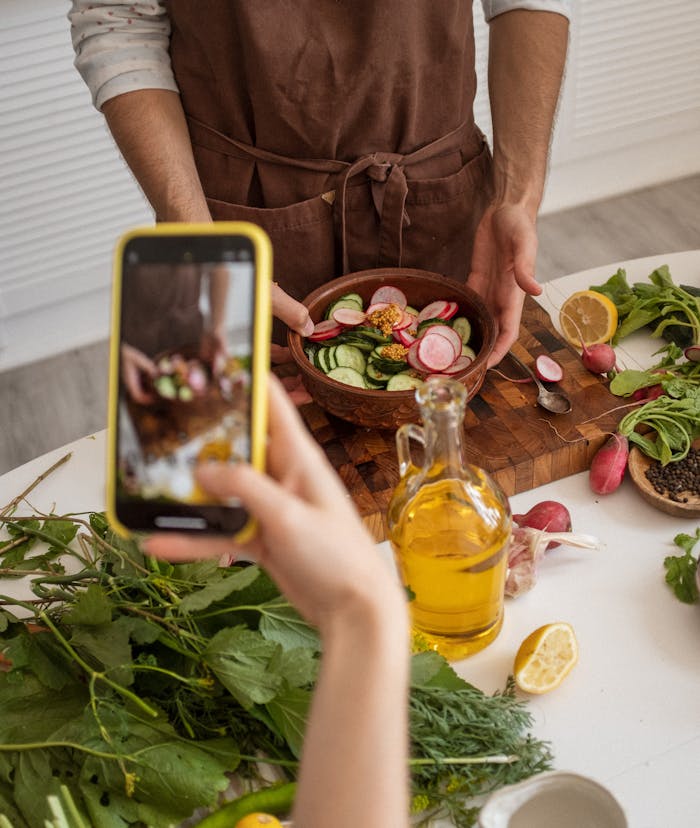 Person Holding a Bowl with Sliced Vegetables